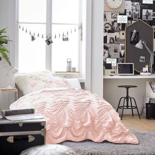 dorm room with a pink bed and black and white industrial study in an alcove
