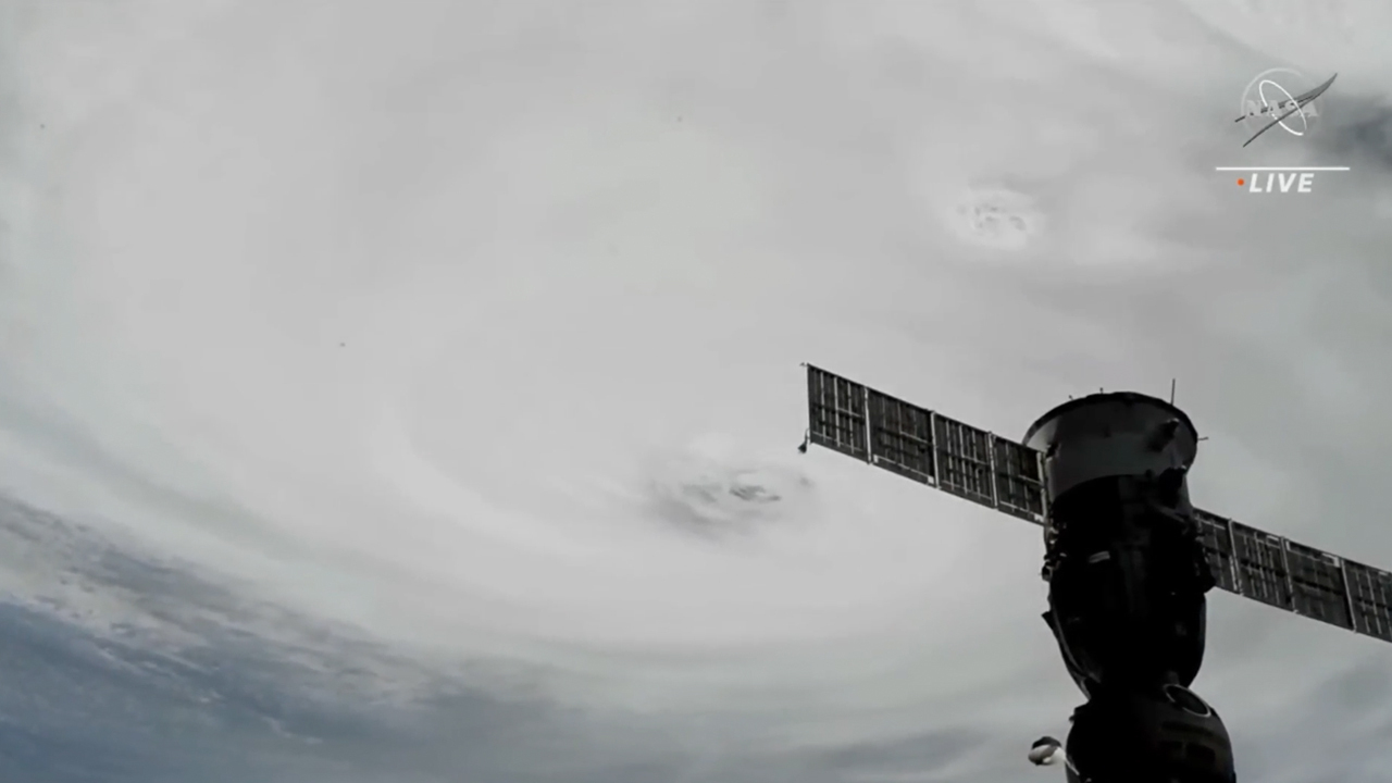 hurricane ian view from space station with solar arrays and station hardware in frame
