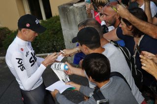 Chris Froome signs autographs before his training ride