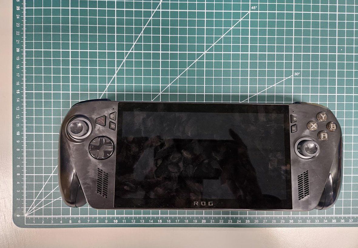 Photographs of an Asus ROG handheld gaming PC taken from FCC filings, showing the device's dimensions, new design, and button and port layout.