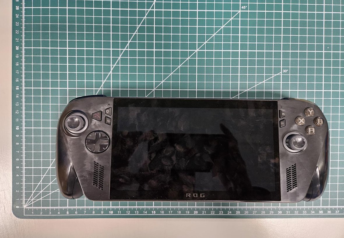 Photographs of an Asus ROG handheld gaming PC taken from FCC filings, showing the device's dimensions, new design, and button and port layout.