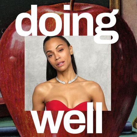 Zoe Saldana's headshot in the middle of a an apple with the words "Doing Well" on the top and bottom.