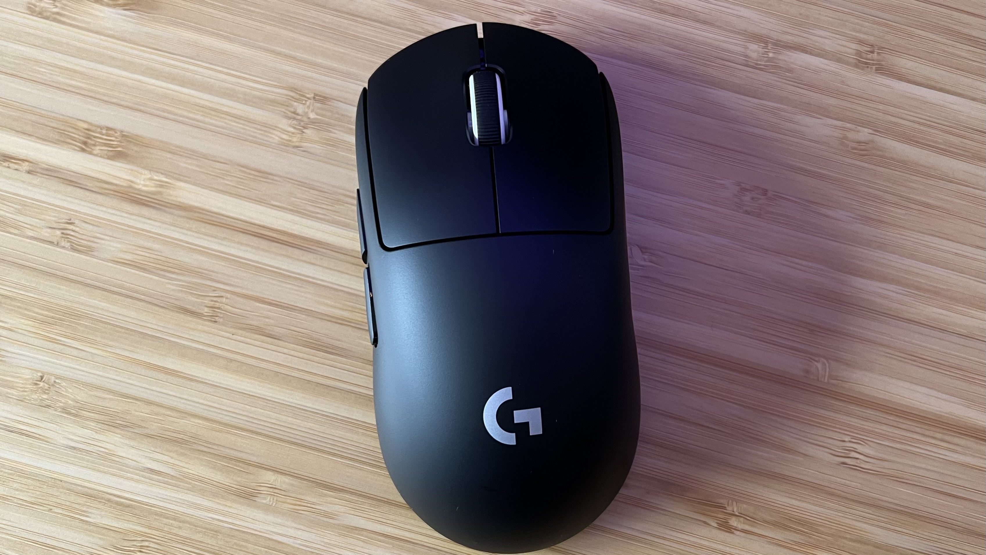 Top down view of the Logitech G Pro X Superlight 2 mouse on a wooden desk