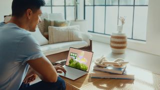 Man using dell laptop on wooden table