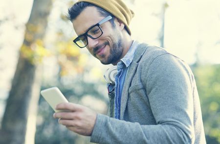 handsome man typing text message