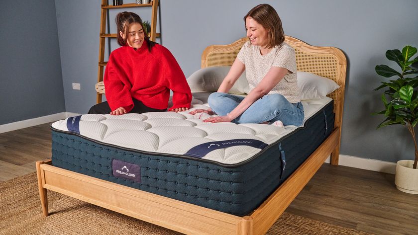 Tom's Guide mattress writers sit on top of the DreamCloud Luxury Hybrid mattress during the testing process at our Sleep Lab