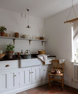 White and gray modern rustic kitchen sink and cabinets designed by deVOL