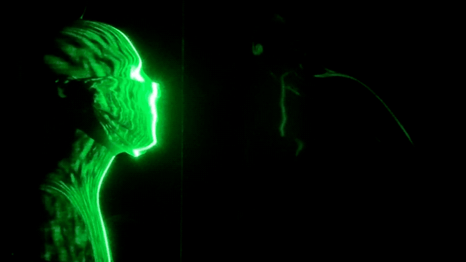 In a new visualization, researchers simulated a cough, which appears as a glowing green vapor flowing from a mannequin's mouth. The visualizations shows that face masks dramatically reduce the spread of cough droplet particles, from 12 feet without a mask to just a few inches with a mask. Homemade cloth masks (top) and cone-style masks (bottom) worked the best at reducing droplet spread, although there was some leakage at the top of the mask in each case.