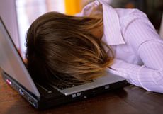 woman face down on a laptop