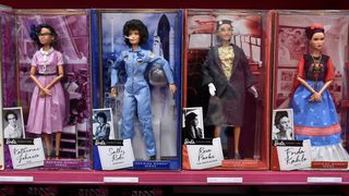 four barbie figures left to right are Katherine Johnson, Sally Ride, Rosa Parks and Frida Kahlo.