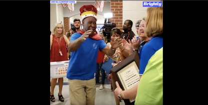 John Lockett is surprised by students and staff at Sand Hill Elementary School.
