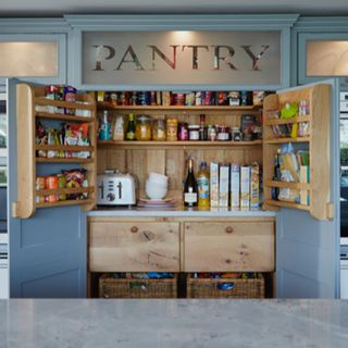 Built-in larder in a blue kitchen