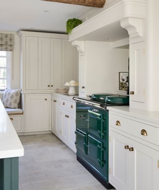 white kitchen with a green AGA cooker and a matching kitchen island