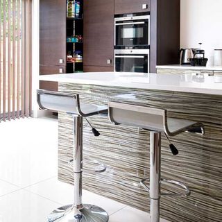 kitchen room with stainles steel stools and kitchen worktop