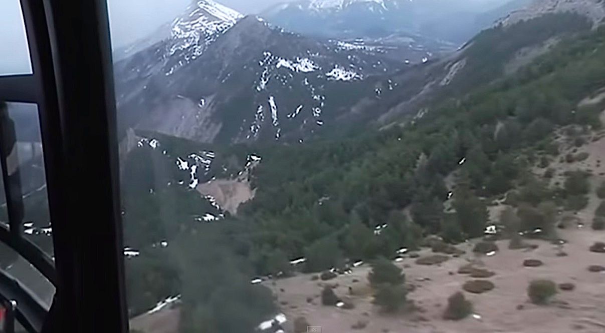 Helicopters search over the wreckage of the Germanwings flight