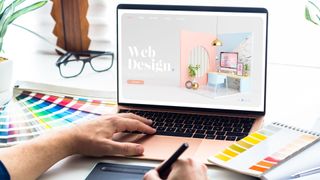 Web design desktop with laptop and tools