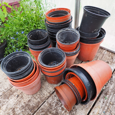 stack of brown and black plant pots