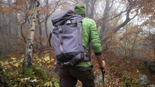 Man hiking using a backpack with long straps