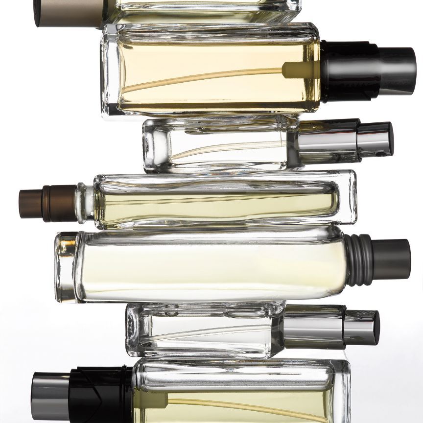 perfume bottles stacked up on a white background