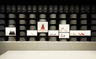 Hats, shoes and jewellery are stored in the accessories area in row upon row of custom-made and individually labelled grey boxes, lined up along black steel shelving
