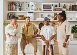 From left, founder and CEO of Crux Shae Hong, and Ghetto Gastro co-founders Pierre Serrao, Lester Walker and Jon Gray. Four men wearing casual clothing standing in front of a kitchen counter with shelves above it.