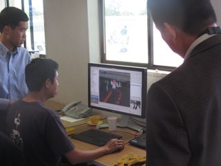 After the trial, NASA Ames' Terry Fong (left) looks at a computer screen showing the K10 rover and its surroundings.