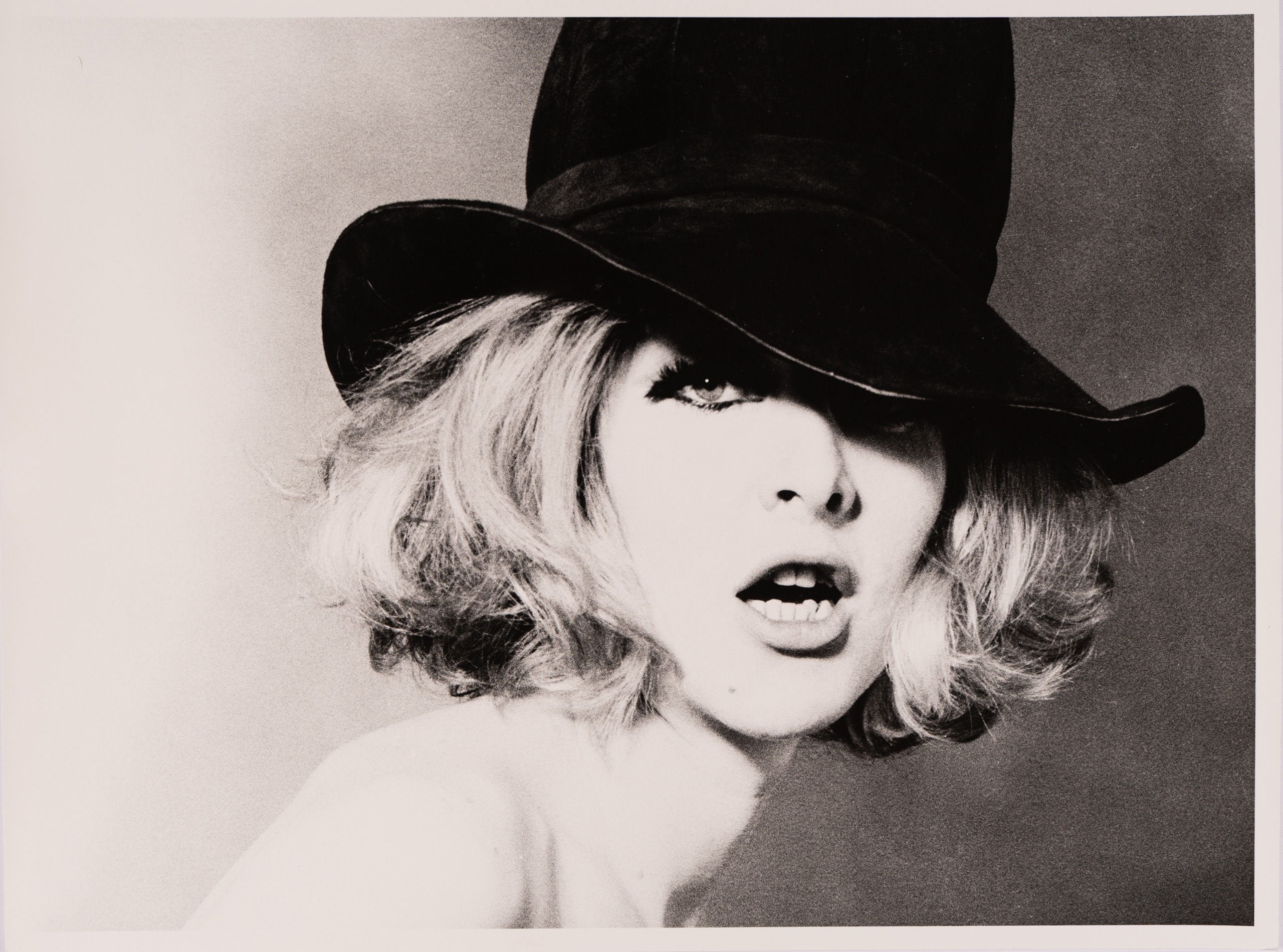 The cover image for Cowboy Kate &amp; Other Stories (1964), a close-up portrait of a woman in a black hat with tousled blonde hair falling across one eye.