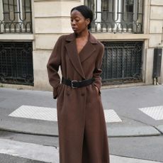 Influencer wears a belted coat