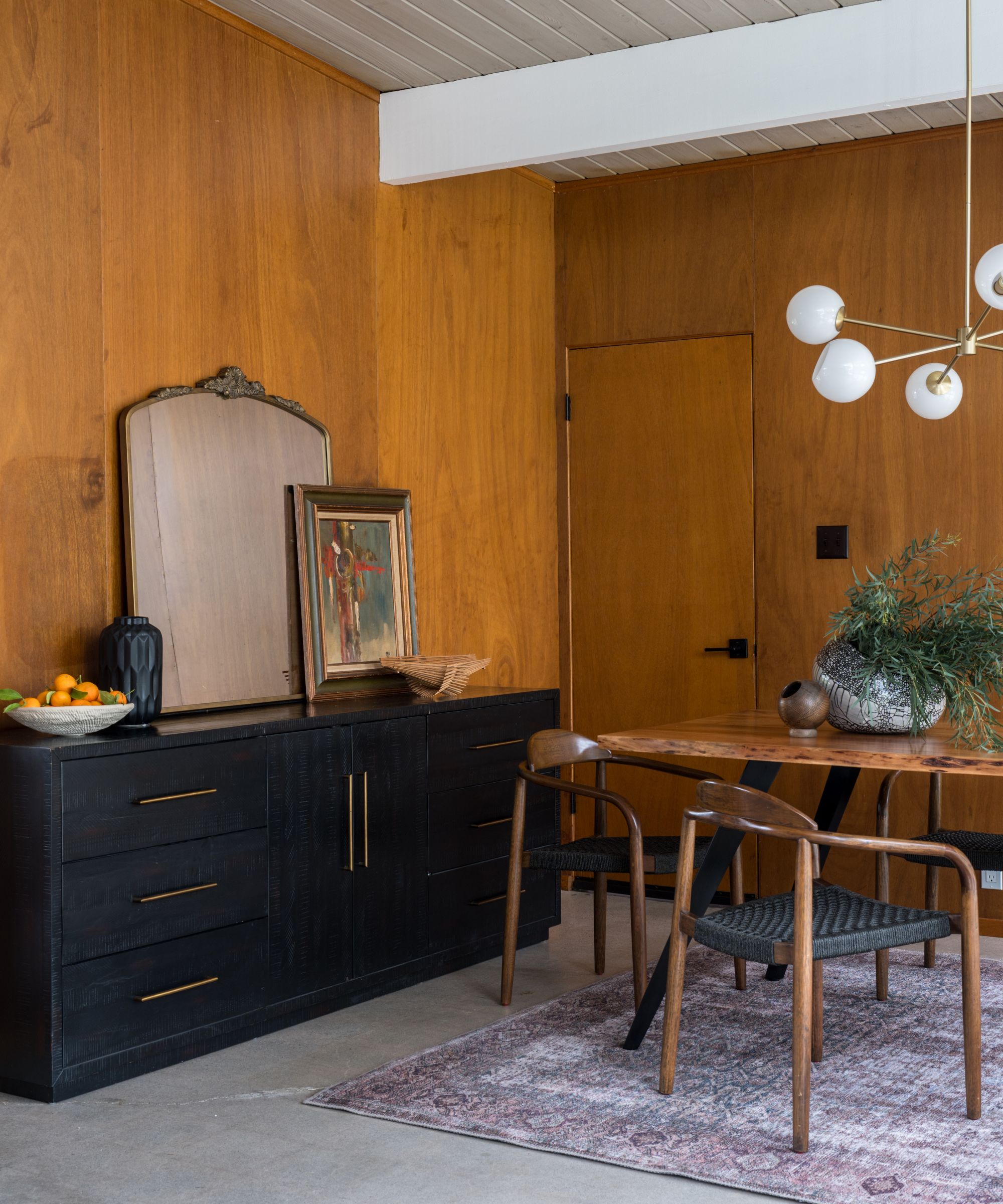 Wood clad dining room with Mid-century Danish Wishbone chairs