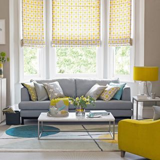 living room with grey sofa and yellow lamp