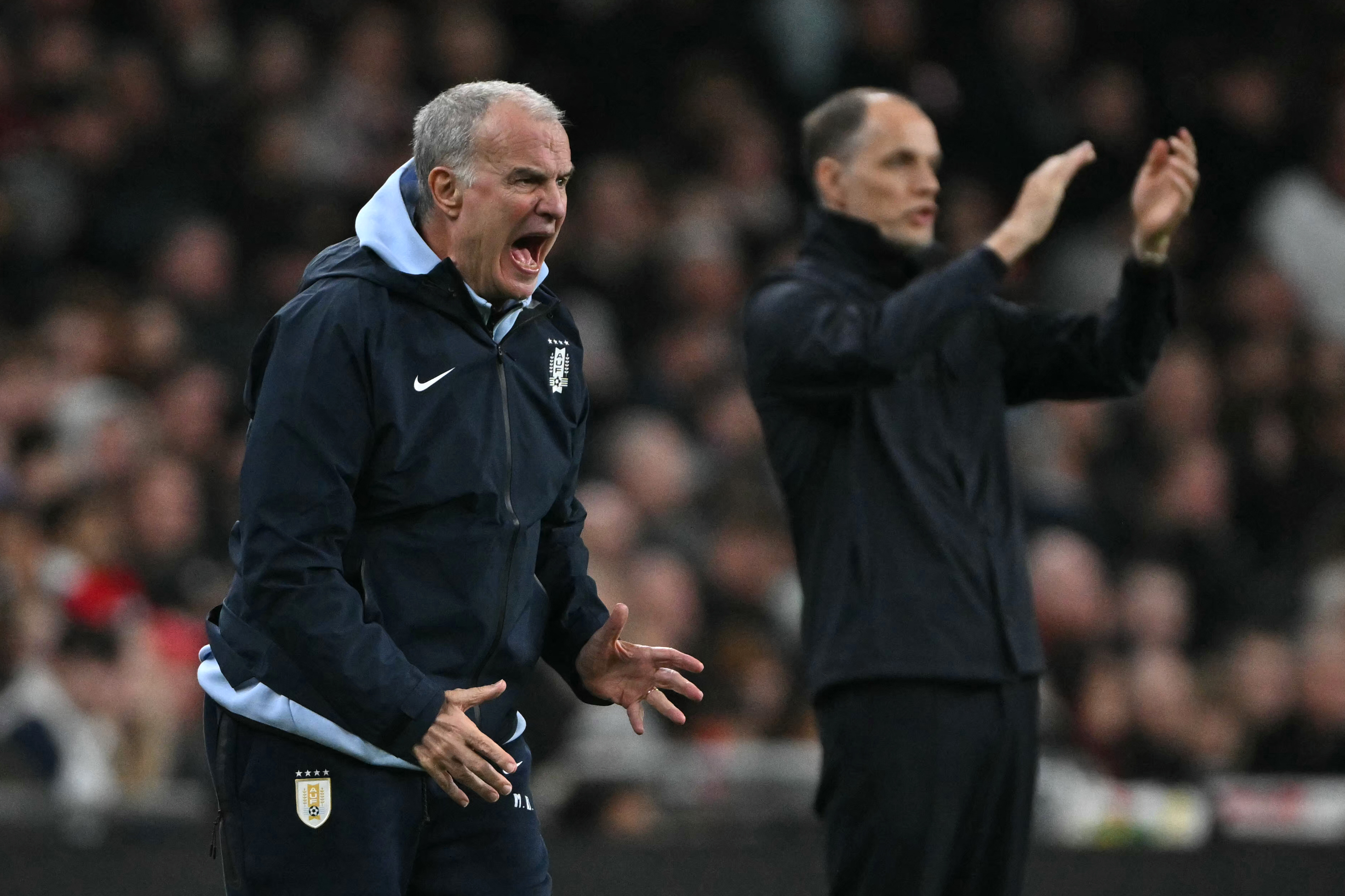 Uruguay's coach Marcelo Bielsa (L) and England's German head coach Thomas Tuchel (R) gesture on the touchline during the friendly International football match between England and Uruguay at Wembley Stadium, west London, on March 27, 2026. (Photo by Glyn KIRK / AFP) / NOT FOR MARKETING OR ADVERTISING USE / RESTRICTED TO EDITORIAL USE