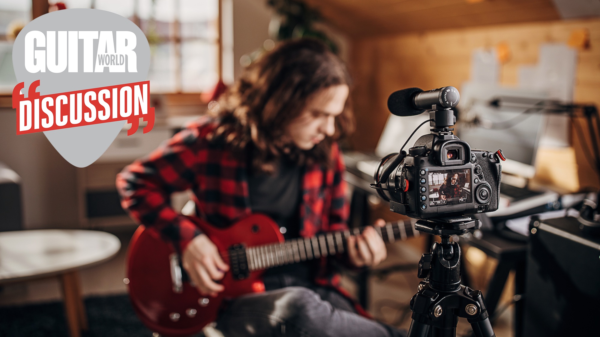 A male guitar player plays electric guitar in front of a rolling camera 