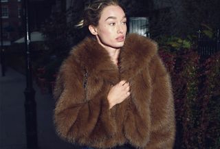 woman in faux fur coat and jeans