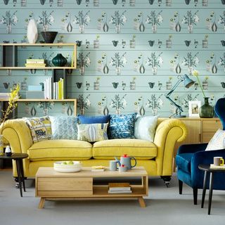 Living room with yellow sofa and wallpaper