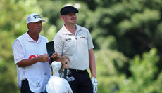 Harry Hall speaks to his caddie