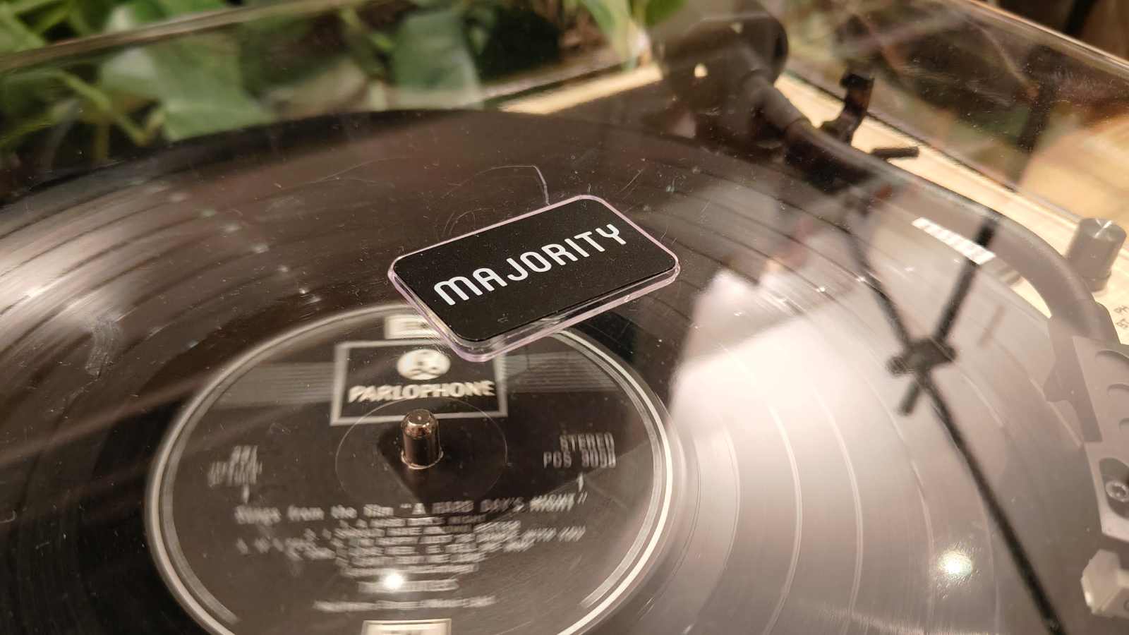 The Majority Folio on a bronze table with plants in the background.