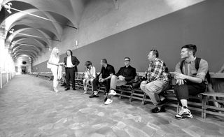 Group of people smiling, sitting on chairs