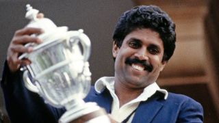 India all rounder Kapil Dev holds aloft the trophy on the balcony after the 1983 Cricket World Cup final Match between India and West Indies at Lord's