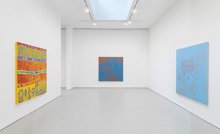 Three painted canvases on walls of gallery