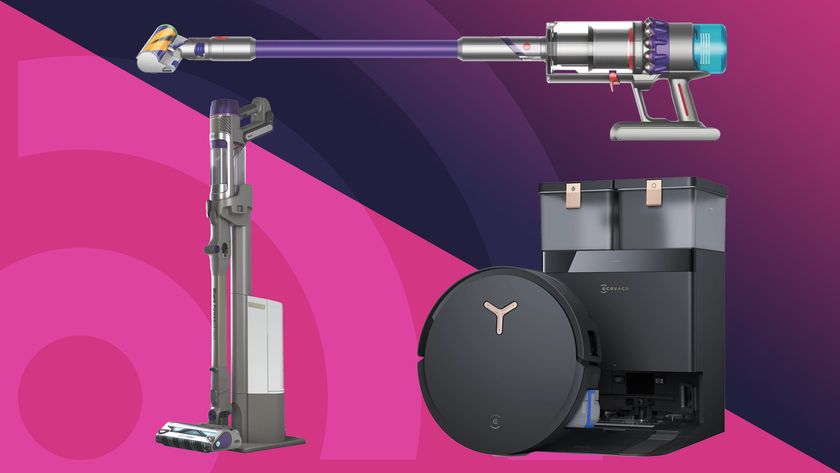 A Shark and Dyson cordless vacuum with an Ecovacs Deebot robot vacuum on a pink and blue background