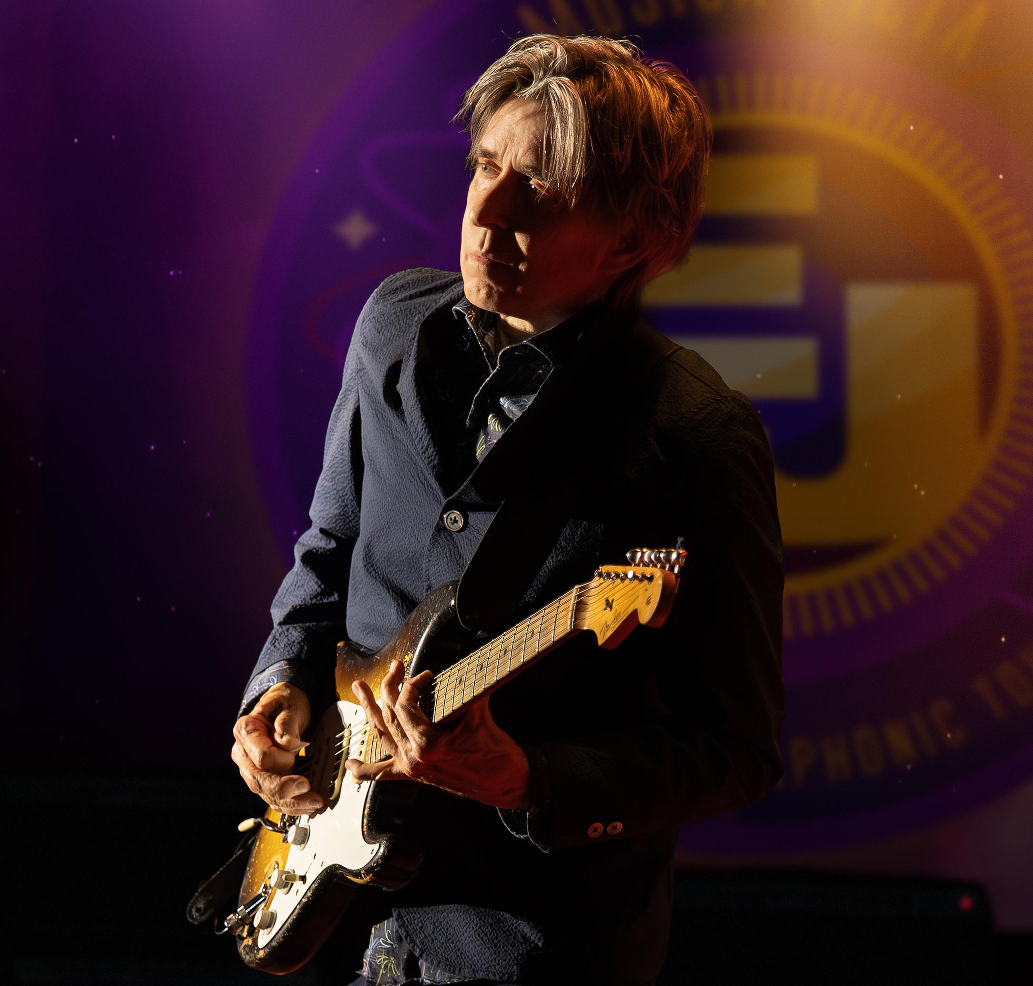Eric Johnson takes a solo onstage with his Fender Strat