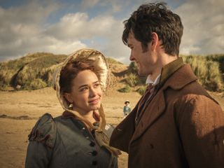 Charlotte (Rose Williams) and Ralph (Cai Bridgen) standing on the beach in Sanditon season three, having an intimate conversation