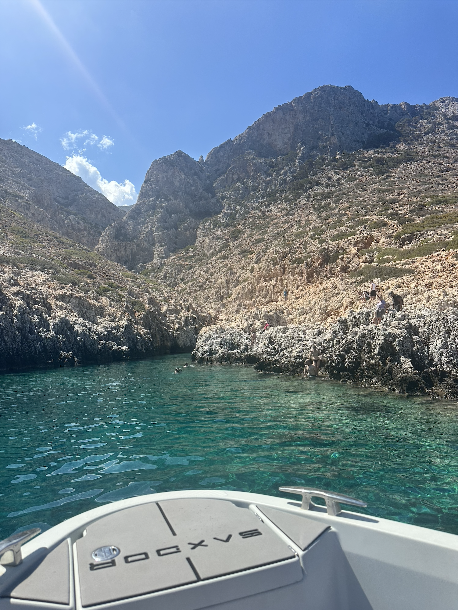 the author walking in Chania, the bow of a boat in an inlet on the sea, an archeological site