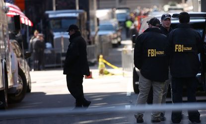 FBI agents stand near the scene of the attacks in Boston, April 16.