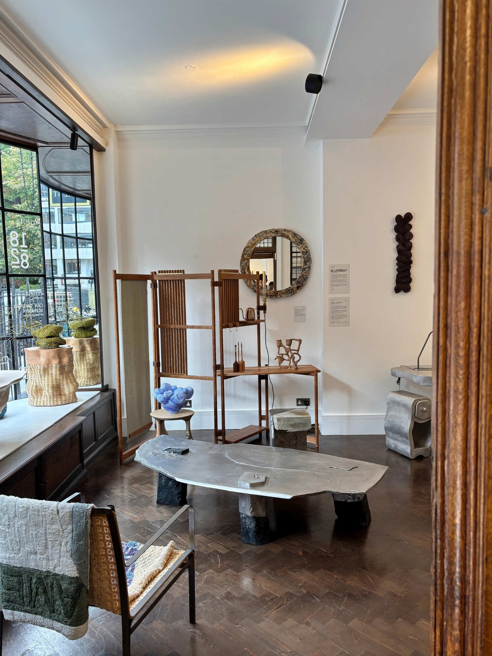 inside of a gallery with modern, eclectic furniture and art