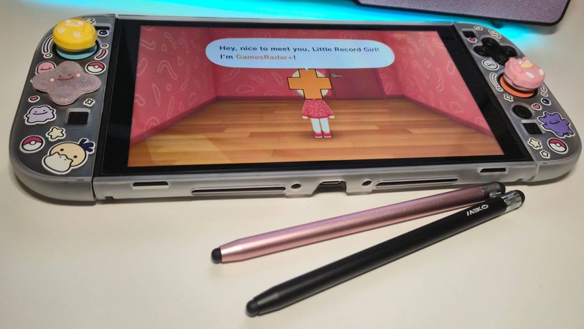 Photo of a pair of stylus pens sitting under a Nintendo Switch 2.