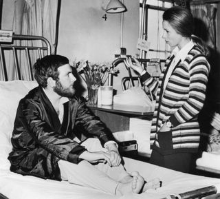 Princess Anne visiting police officer Michael Hills at St George's Hospital in London after he was shot in the stomach while attempting to intervene during the attempt to kidnap the Princess in the Mall, 25th March 1974.