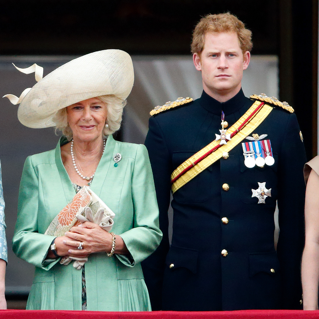 Queen Camilla and Prince Harry standing next to each other at Trooping the Colour 2015