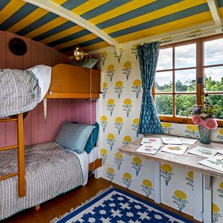 shepherd's hut with bunk bed and blue carpet