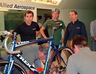 Lance Armstrong strolls into the tunnel to check on the prep for his track bike test is coming.